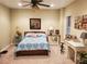 Carpeted bedroom features a decorative bedspread, large window, desk, and a view of additional decor at 101 Brendylynn Trce, Woodstock, GA 30188