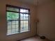 Bedroom with view of landscaped yard through large window at 101 Brendylynn Trce, Woodstock, GA 30188
