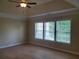Bright bedroom with multiple windows providing ample natural light and backyard views at 101 Brendylynn Trce, Woodstock, GA 30188