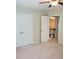 A carpeted bedroom with white doors, neutral walls, and a ceiling fan at 101 Brendylynn Trce, Woodstock, GA 30188