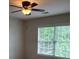 Bedroom view showing a ceiling fan and natural light from a large window at 101 Brendylynn Trce, Woodstock, GA 30188
