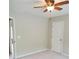 Bedroom features ceiling fan, neutral walls, plush carpet, and a door for access at 101 Brendylynn Trce, Woodstock, GA 30188