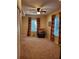 Bright bonus room has a ceiling fan, plush carpet, and two windows with colorful striped curtains at 101 Brendylynn Trce, Woodstock, GA 30188