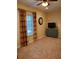 Finished bonus room includes neutral carpet, a ceiling fan, and large window with attractive striped curtains at 101 Brendylynn Trce, Woodstock, GA 30188