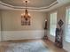 Elegant dining room with decorative rug, chandelier, and wainscoting at 101 Brendylynn Trce, Woodstock, GA 30188
