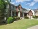 A charming two-story brick house with a covered porch, a two-car garage, and well-kept landscaping at 101 Brendylynn Trce, Woodstock, GA 30188