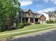 A two-story brick house with a covered porch, a two-car garage, and well-maintained landscaping at 101 Brendylynn Trce, Woodstock, GA 30188