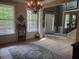 Bright foyer showcasing hardwood floors, a decorative chandelier, and views into multiple rooms at 101 Brendylynn Trce, Woodstock, GA 30188