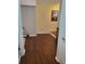 Hallway with dark wood flooring and a painting on the wall at 101 Brendylynn Trce, Woodstock, GA 30188