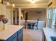 Kitchen area with gray island and white cabinets open to dining area at 101 Brendylynn Trce, Woodstock, GA 30188