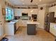 Open kitchen with white cabinets, stainless appliances, gray island, and stone backsplash at 101 Brendylynn Trce, Woodstock, GA 30188