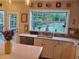 Bright kitchen with updated countertops and a view of the green backyard from over the sink at 101 Brendylynn Trce, Woodstock, GA 30188