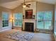 Bright living room features a fireplace, vaulted ceiling, and large windows overlooking the backyard at 101 Brendylynn Trce, Woodstock, GA 30188