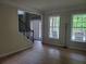 Living room with hardwood floors, natural light, and staircase to second floor at 101 Brendylynn Trce, Woodstock, GA 30188