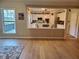 Open living space with light wood flooring, open to a modern eat-in kitchen at 101 Brendylynn Trce, Woodstock, GA 30188