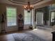 Bright living room featuring hardwood floors, a decorative chandelier, and large windows at 101 Brendylynn Trce, Woodstock, GA 30188