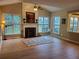 Bright living room features a fireplace, vaulted ceiling, and large windows overlooking the backyard at 101 Brendylynn Trce, Woodstock, GA 30188