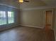 Spacious main bedroom featuring wood floors, a tray ceiling and lots of natural light from windows at 101 Brendylynn Trce, Woodstock, GA 30188