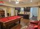 Entertaining basement includes pool table, wet bar, stainless fridge, and adjacent lounge area at 101 Brendylynn Trce, Woodstock, GA 30188