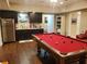 Finished rec room shows a pool table, wet bar with stainless steel refrigerator, and wood-look flooring at 101 Brendylynn Trce, Woodstock, GA 30188