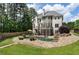 Backyard featuring a stone patio, swimming pool with waterfall, and a well-manicured lawn at 2660 Pete Shaw Rd, Marietta, GA 30066