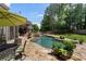 Beautiful backyard featuring a large inground pool, stone patio, rock waterfall and mature landscaping at 2660 Pete Shaw Rd, Marietta, GA 30066