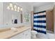 Bathroom with a vanity, toilet, and shower-tub combo with a striped curtain at 2660 Pete Shaw Rd, Marietta, GA 30066