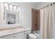Well-lit bathroom with a shower-tub combo and large mirror at 2660 Pete Shaw Rd, Marietta, GA 30066