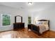 Comfortable bedroom featuring hardwood floors, a large window, and a dark dresser at 2660 Pete Shaw Rd, Marietta, GA 30066