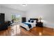 Well-lit bedroom with hardwood floors, a comfortable bed, and ample closet space at 2660 Pete Shaw Rd, Marietta, GA 30066