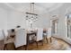 Dining room with hardwood floors, elegant chandelier, and ample natural light at 2660 Pete Shaw Rd, Marietta, GA 30066
