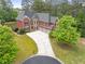 Stunning two-story brick home with a three-car garage and spacious driveway in a lush, green neighborhood at 2660 Pete Shaw Rd, Marietta, GA 30066