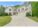 Elegant stucco home featuring a three-car garage, manicured lawn, and stone accents at 2660 Pete Shaw Rd, Marietta, GA 30066