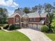 Stately brick home featuring a three-car garage, manicured lawn, and stone accents at 2660 Pete Shaw Rd, Marietta, GA 30066