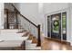 Elegant foyer featuring hardwood floors, staircase with iron railings, and front door with decorative glass at 2660 Pete Shaw Rd, Marietta, GA 30066