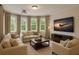 Inviting living room featuring a large screen TV, comfortable seating, and abundant natural light at 2660 Pete Shaw Rd, Marietta, GA 30066