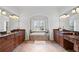A beautifully designed main bathroom with and vanities and a soaking tub at 2660 Pete Shaw Rd, Marietta, GA 30066