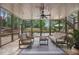 Relaxing screened-in porch featuring stone floors, a ceiling fan, and an exterior view of the backyard pool at 2660 Pete Shaw Rd, Marietta, GA 30066