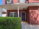 Charming front porch of a brick home with white columns and a well-maintained front yard at 417 Bell Flower Trl, Locust Grove, GA 30248