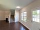 Inviting living room featuring hardwood floors, a fireplace, and natural light at 417 Bell Flower Trl, Locust Grove, GA 30248