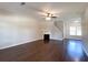 Spacious living room with hardwood floors, a fireplace, and abundant natural light at 417 Bell Flower Trl, Locust Grove, GA 30248