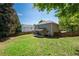 View of backyard, covered patio, and mature trees at 101 Magnolia Creek Dr, Canton, GA 30115