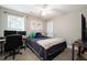 Neutral bedroom with ceiling fan, big window and comfy bed next to desk and monitor at 101 Magnolia Creek Dr, Canton, GA 30115