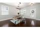 Bright dining room with a modern table and bench set, hardwood floors, and natural light from the windows at 101 Magnolia Creek Dr, Canton, GA 30115