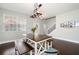 Bright dining room features wood table with benches, modern chandelier, and large windows with lots of natural light at 101 Magnolia Creek Dr, Canton, GA 30115