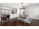 Elegant dining room showcasing a modern table setting, hardwood floors, and ample natural light at 101 Magnolia Creek Dr, Canton, GA 30115