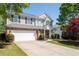 Beautiful two-story home featuring gray siding, brick accents, a two-car garage and a well-maintained front yard at 101 Magnolia Creek Dr, Canton, GA 30115