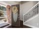 Welcoming foyer with a decorative front door, hardwood floors, staircase with iron spindles, and a neutral color scheme at 101 Magnolia Creek Dr, Canton, GA 30115