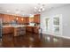 Well-lit kitchen boasts wood cabinets, an island with seating, and stainless steel appliances with convenient access to the patio at 101 Magnolia Creek Dr, Canton, GA 30115