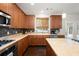 Modern kitchen features wood cabinets, an island with seating, and stainless steel appliances providing an ideal cooking space at 101 Magnolia Creek Dr, Canton, GA 30115